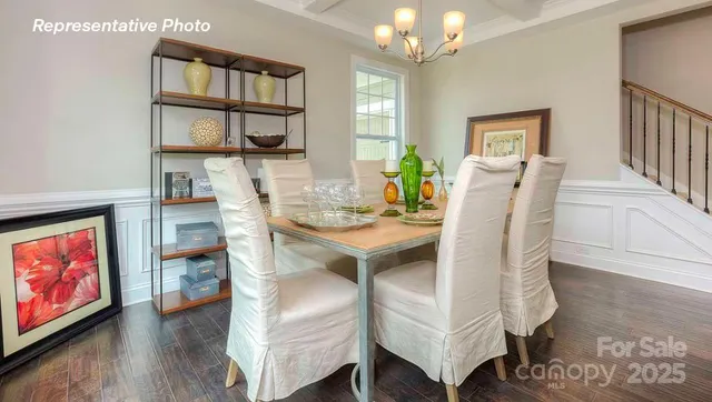 a view of a dining room with furniture and a chandelier
