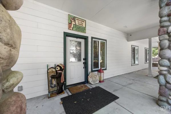 a kitchen with a stove a sink and a wooden cabinets