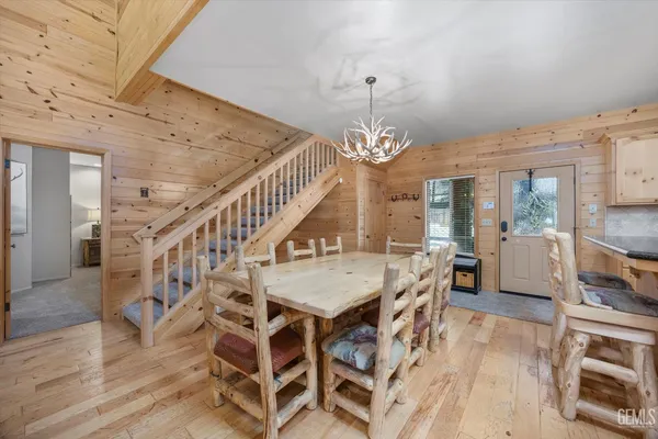 a kitchen with stainless steel appliances granite countertop a refrigerator a stove and a wooden floors