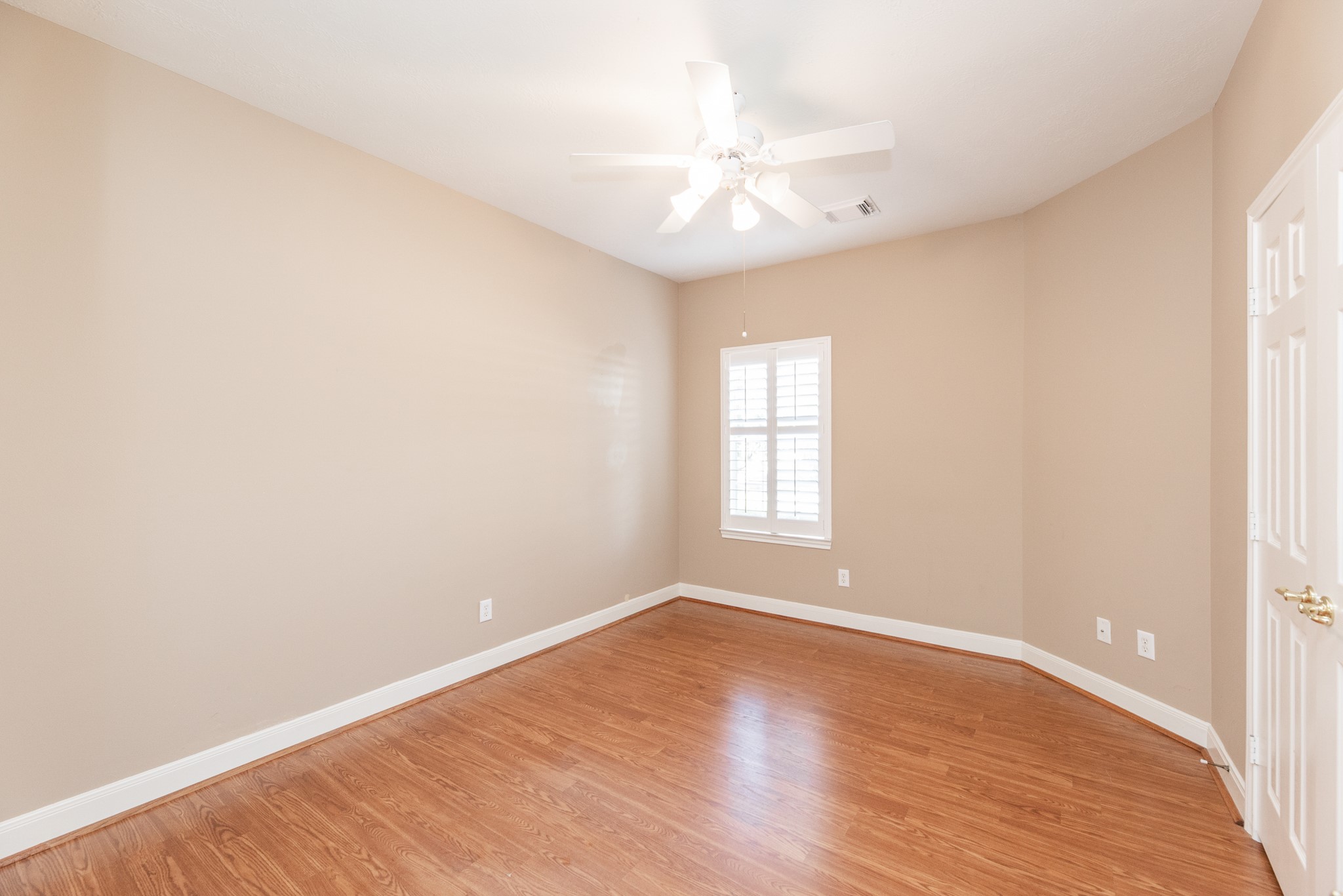 1222 Brinson Court Spring, TX 77379 - Photo 32 of 35 an empty room with wooden floor and windows