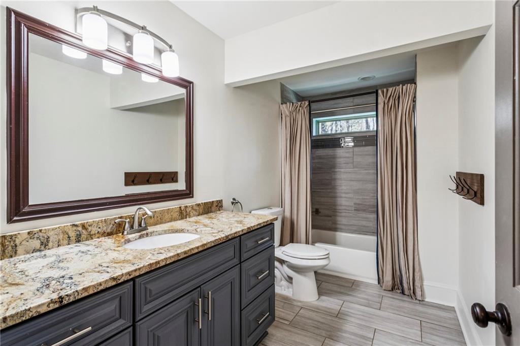 23 Midway Road Marietta, GA 30064 - Photo 15 of 32 a bathroom with a granite countertop sink toilet and shower