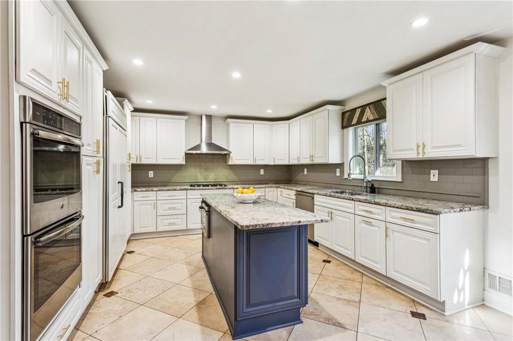 23 Midway Road Marietta, GA 30064 - Photo 3 of 32 a kitchen with stainless steel appliances granite countertop a stove top oven a sink and dishwasher a refrigerator with white cabinets
