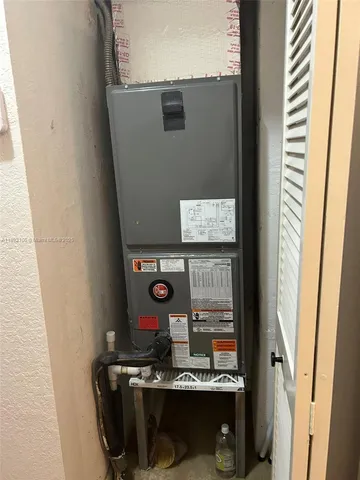 a room with water heater and utility racks