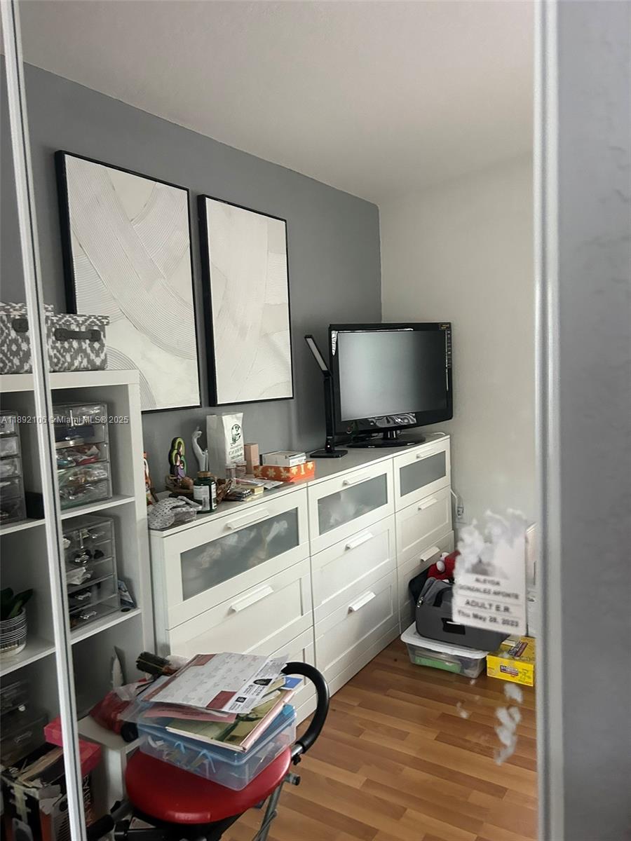 18730 Southwest 25th Court, Unit 18730 Miramar, FL 33029 - Photo 14 of 30 a room with furniture and a flat screen tv