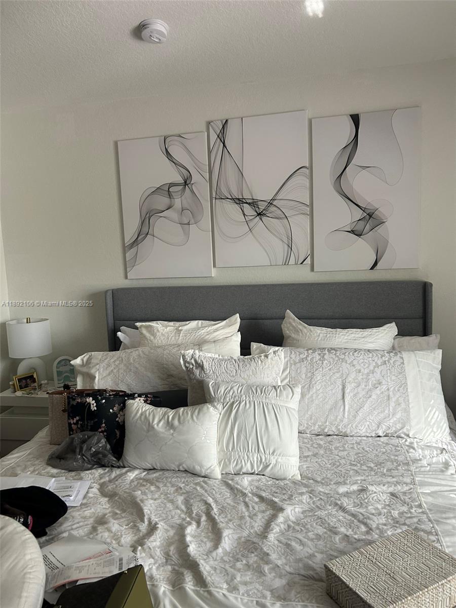 18730 Southwest 25th Court, Unit 18730 Miramar, FL 33029 - Photo 15 of 30 a bedroom with a bed and the night stand