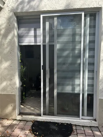a view of a glass door of the house
