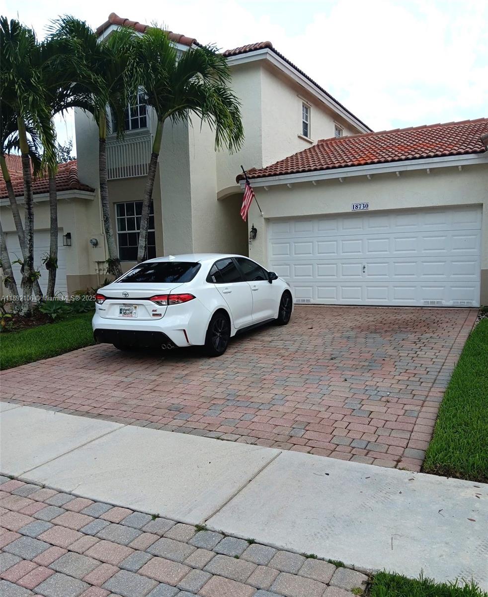 18730 Southwest 25th Court, Unit 18730 Miramar, FL 33029 - Photo 30 of 30 a car parked in front of white house