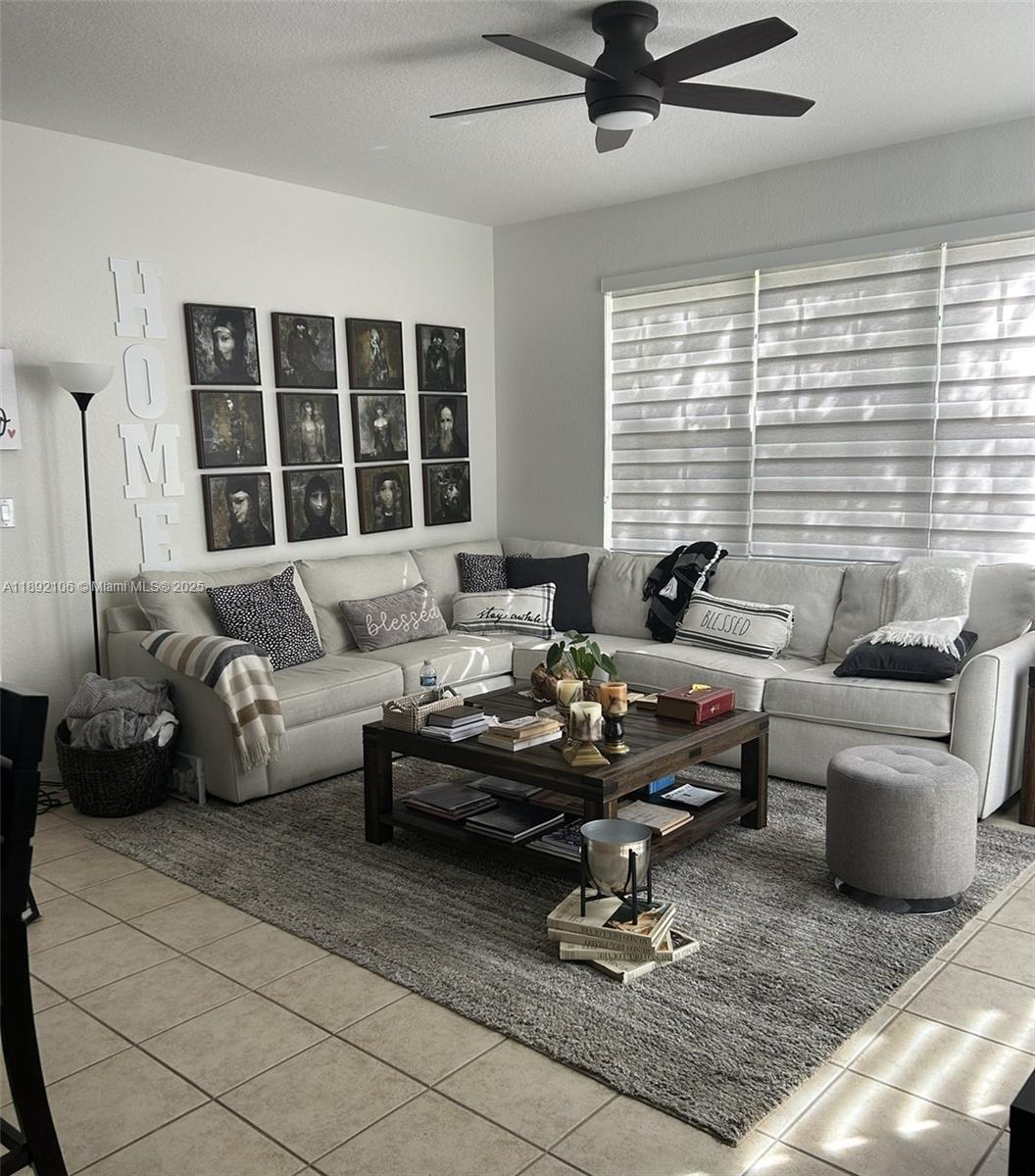 18730 Southwest 25th Court, Unit 18730 Miramar, FL 33029 - Photo 5 of 30 a living room with furniture and floor to ceiling windows