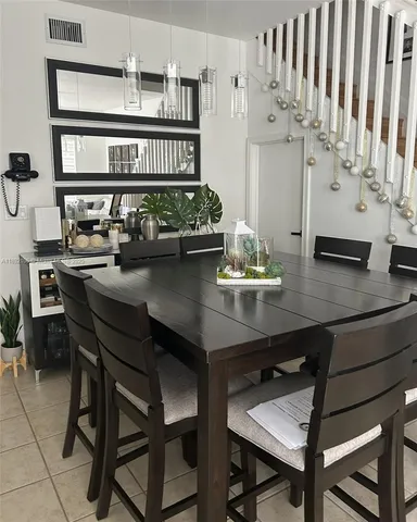 a kitchen with stainless steel appliances a table and chairs in it