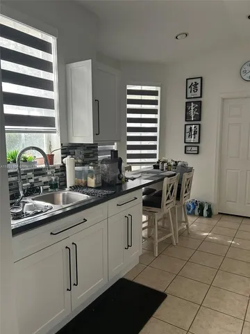 a kitchen with a sink and cabinets