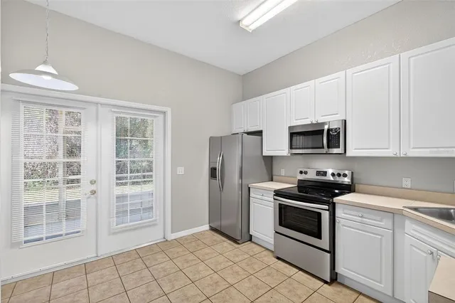 a kitchen with stainless steel appliances a white stove top oven and a refrigerator