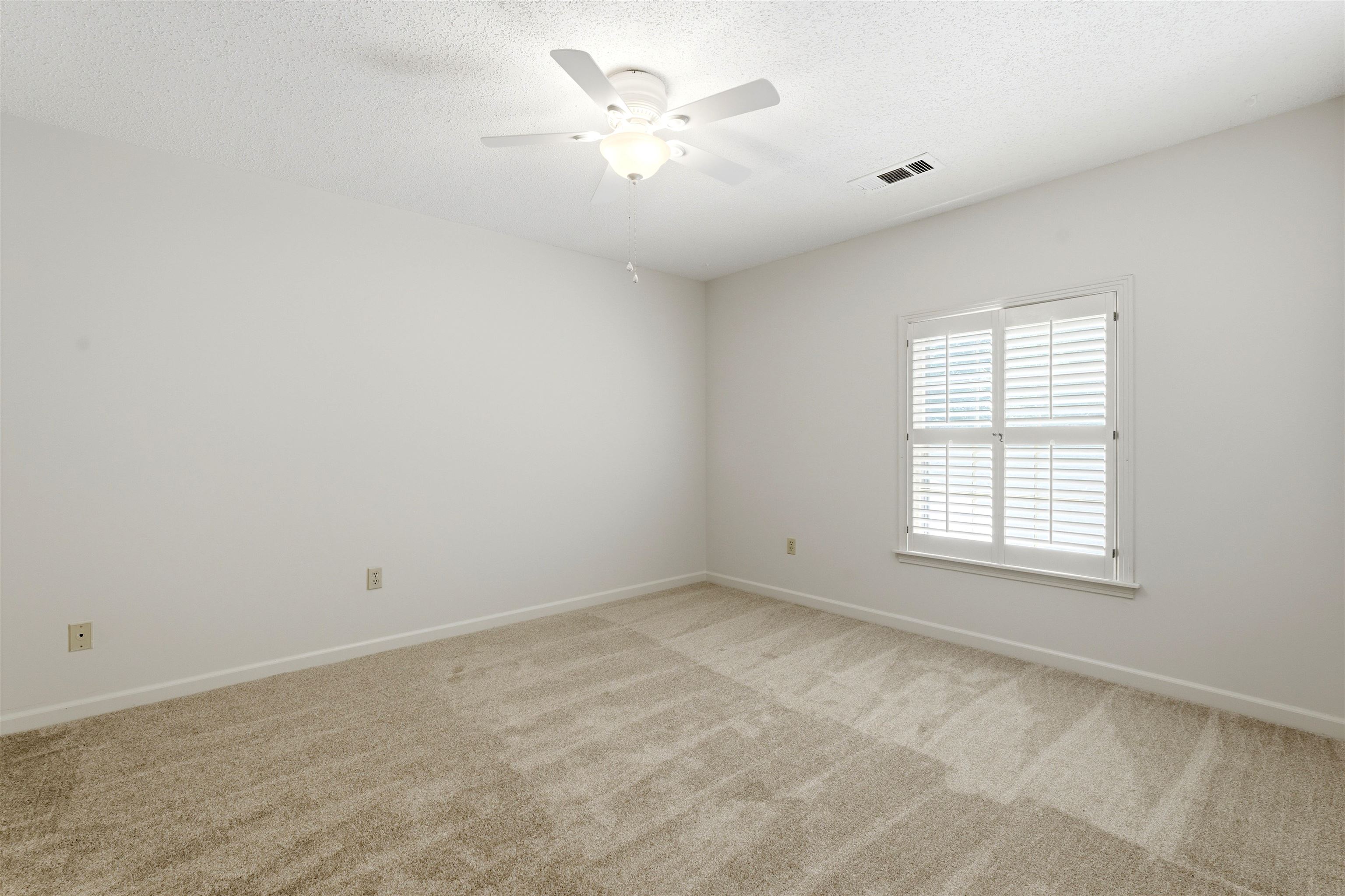 1984 Allenby Road Germantown, TN 38139 - Photo 32 of 37 Carpeted room with white walls, a single window featuring white plantation shutters, and a ceiling fan with integrated lighting