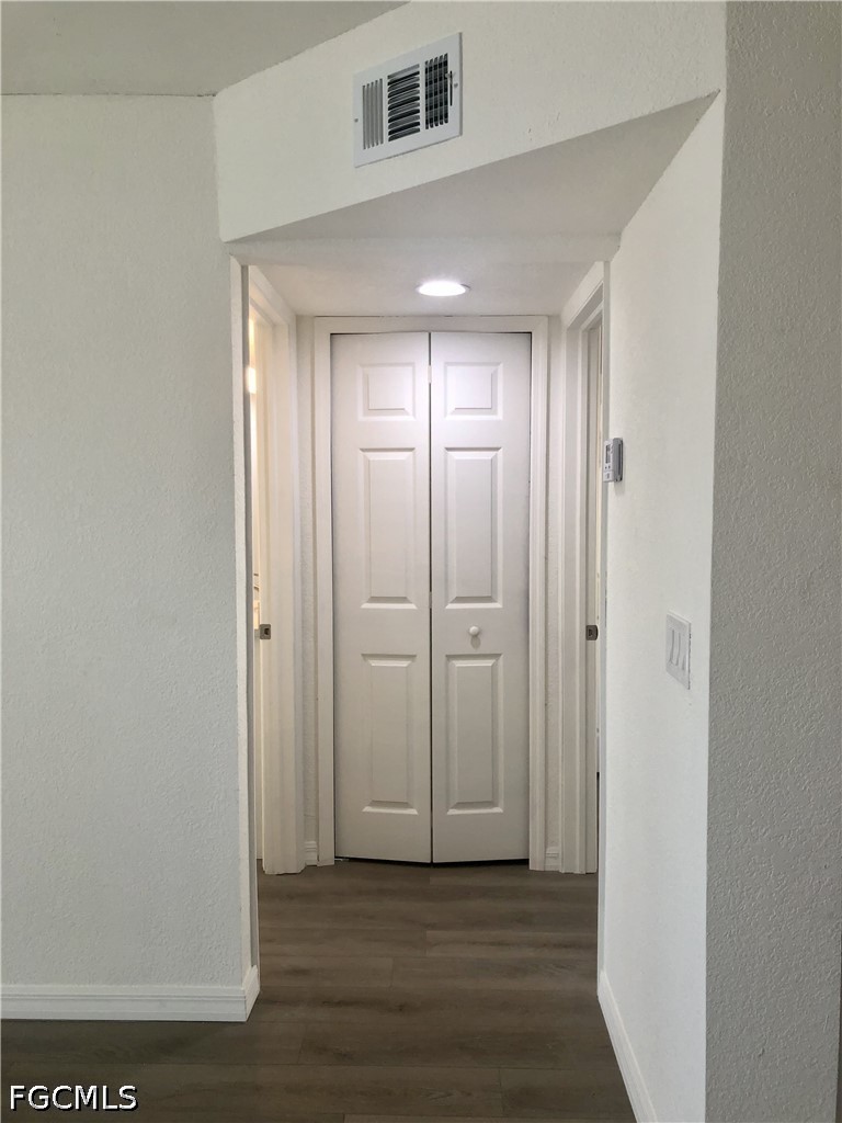 16881 Davis Road, Unit 214 Fort Myers, FL 33908 - Photo 22 of 46 a view of a hallway with wooden floor