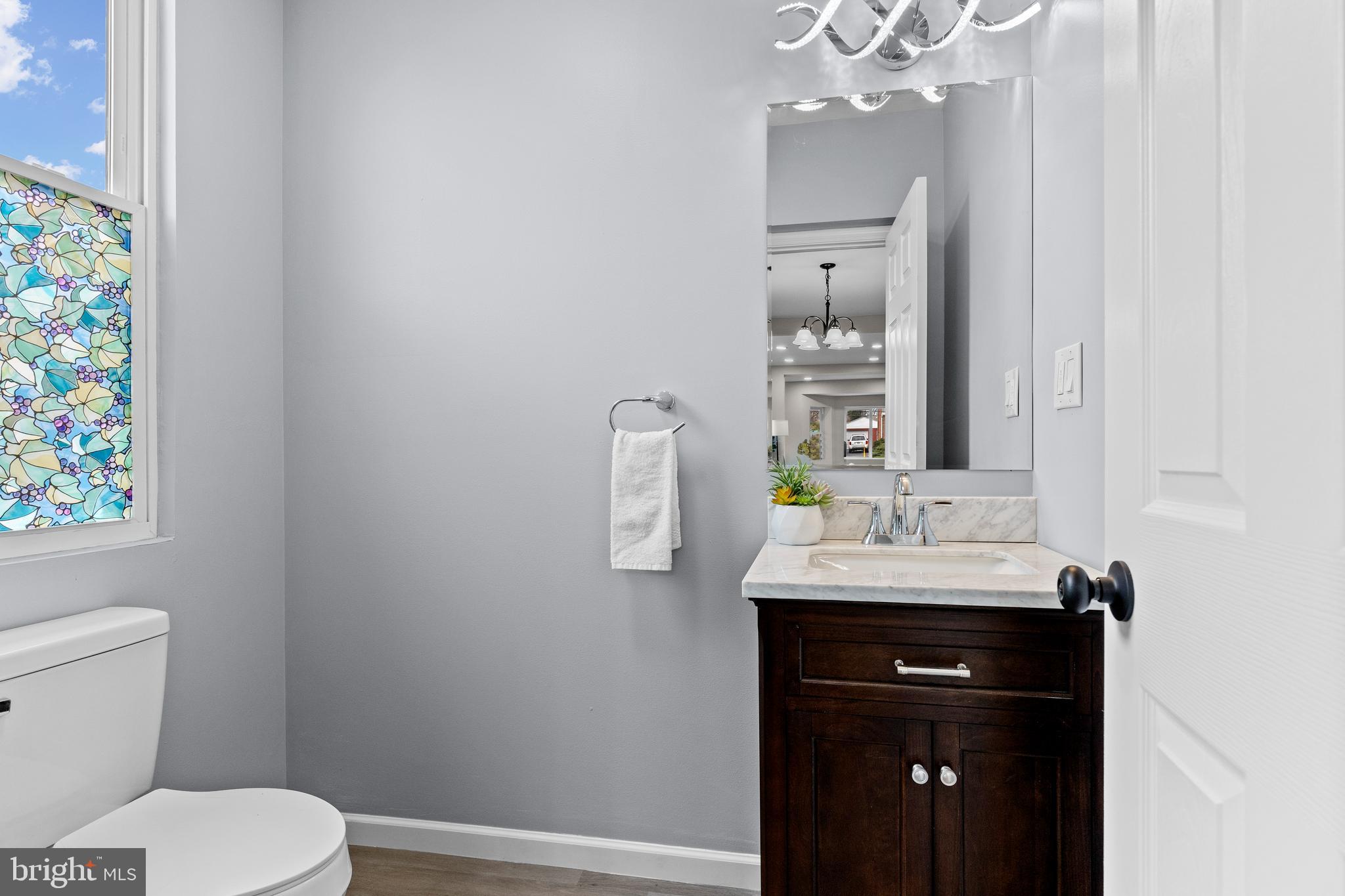 3507 Union Deposit Road Harrisburg, PA 17109 - Photo 12 of 37 a bathroom with a granite countertop sink a toilet and mirror