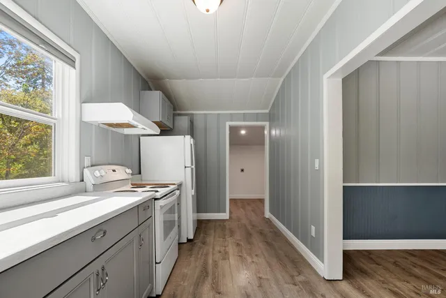 a kitchen with stainless steel appliances a sink a stove and a window