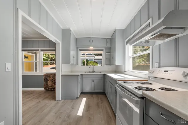 a kitchen with a stove a sink and a refrigerator