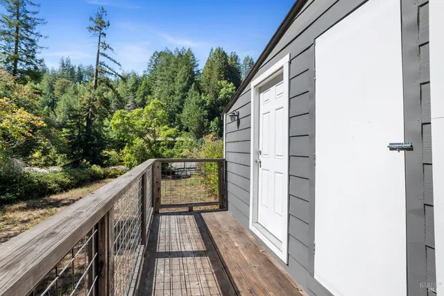a balcony with wooden floor and fence