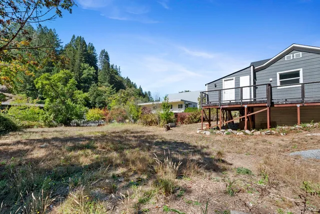 a big house with large trees in front of it