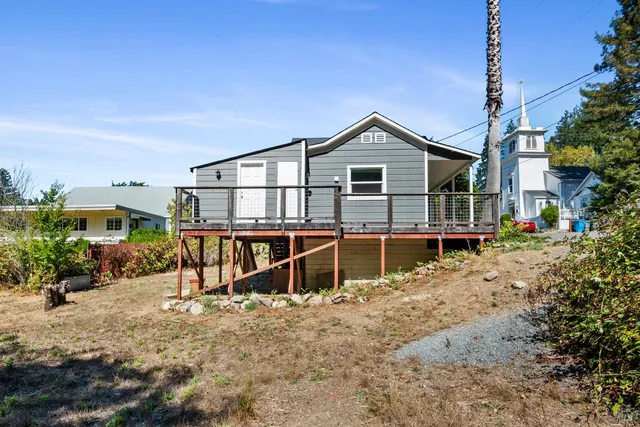 a view of a house with a wooden deck