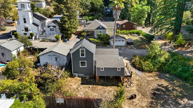 an aerial view of multiple houses with a yard