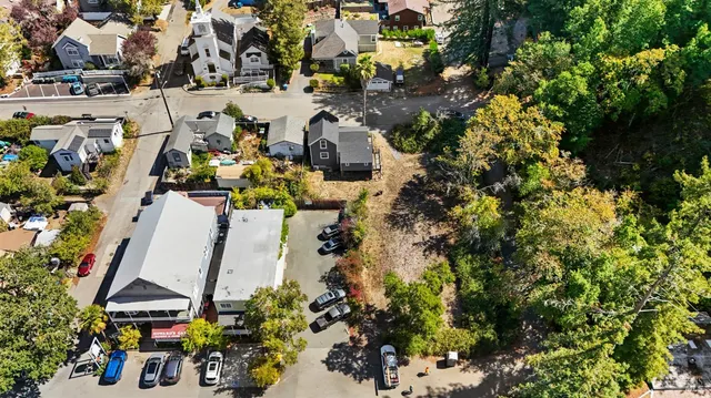an aerial view of multiple houses with yard