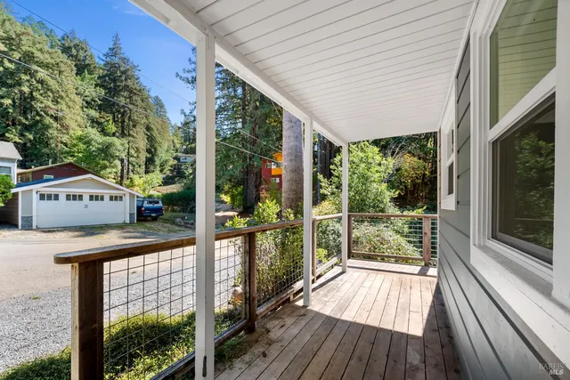 a view of a house with a balcony and wooden floor