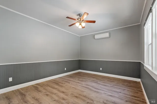 a view of a room with wooden floor and fan