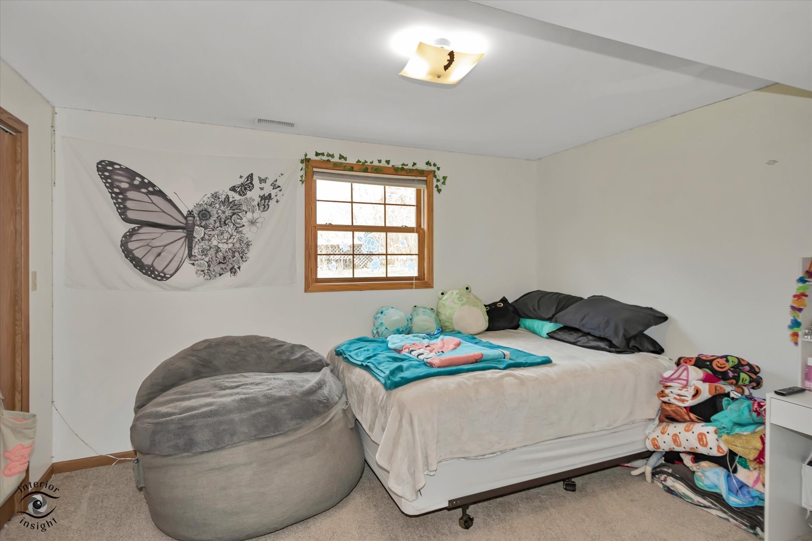 24412 Kings Road Crete, IL 60417 - Photo 20 of 28 a bedroom with a bed and a chandelier