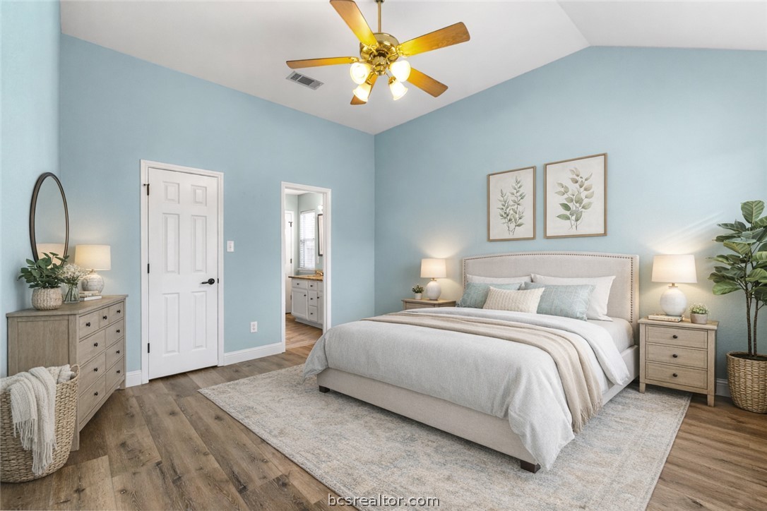 3709 Springfield Drive College Station, TX 77845 - Photo 10 of 23 a spacious bedroom with a bed and a chandelier