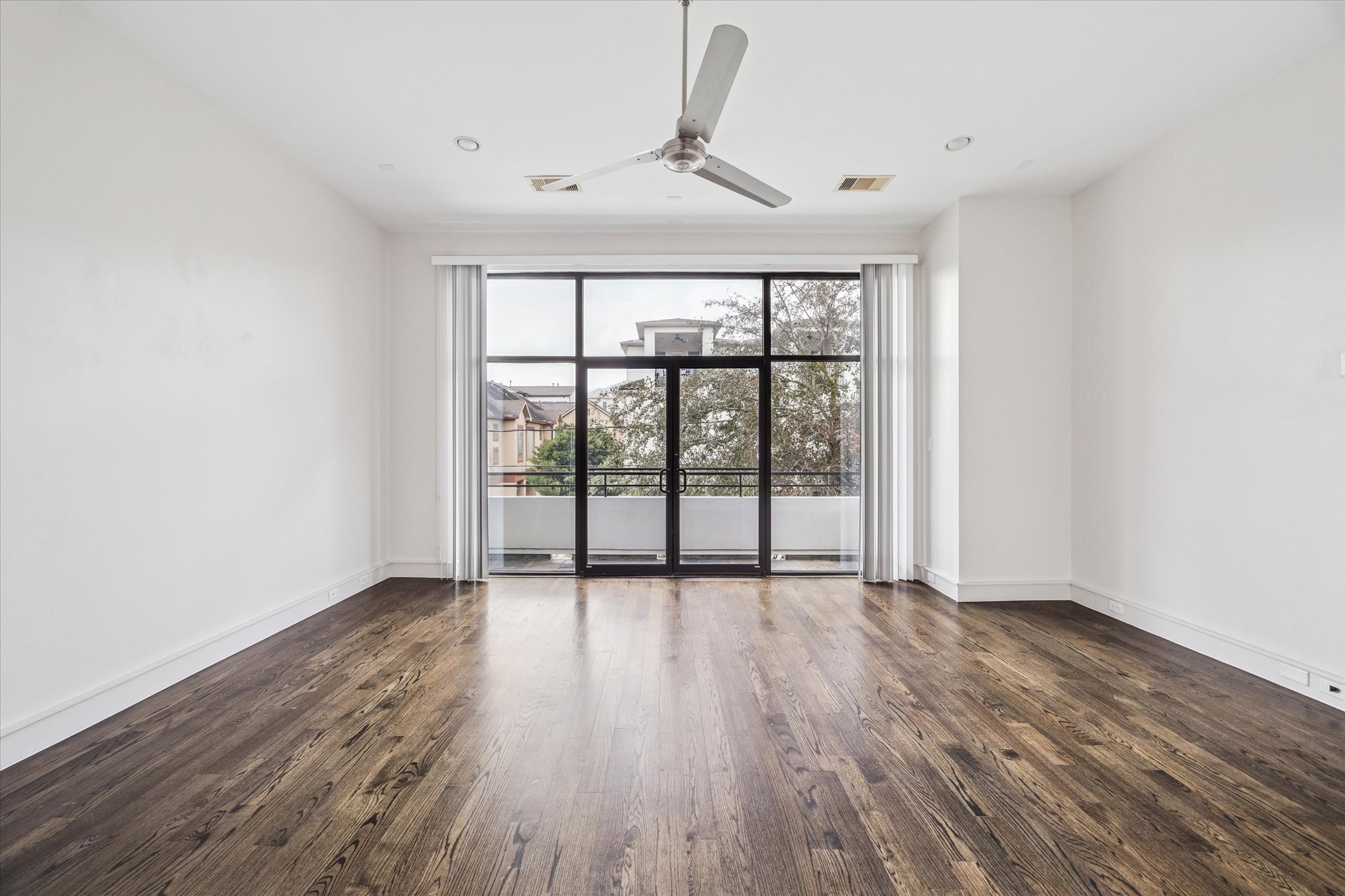 1522 Knox Street Houston, TX 77007 - Photo 13 of 43 a view of an empty room with wooden floor and a window