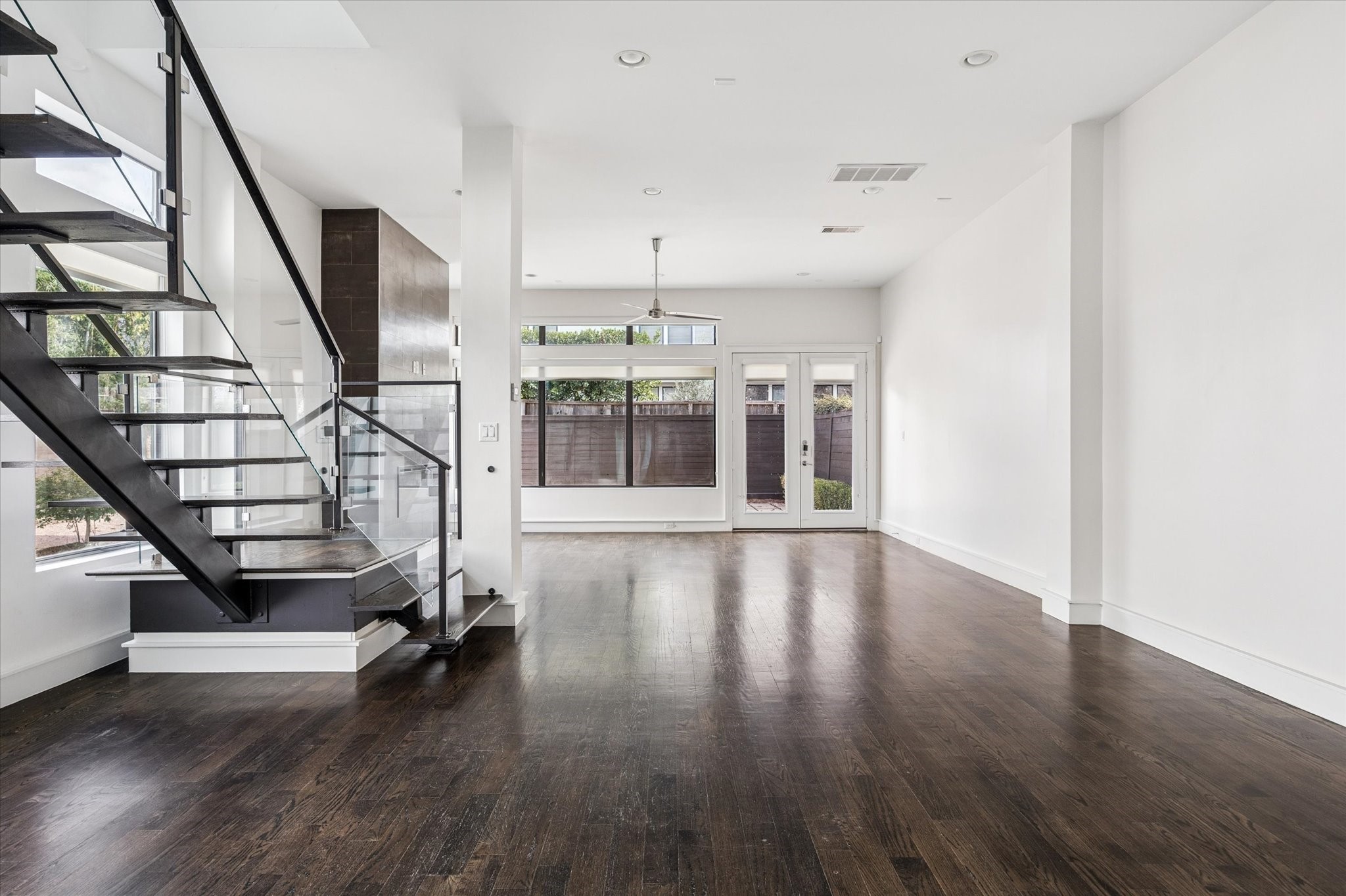 1522 Knox Street Houston, TX 77007 - Photo 2 of 43 a view of an empty room with wooden floor and a window