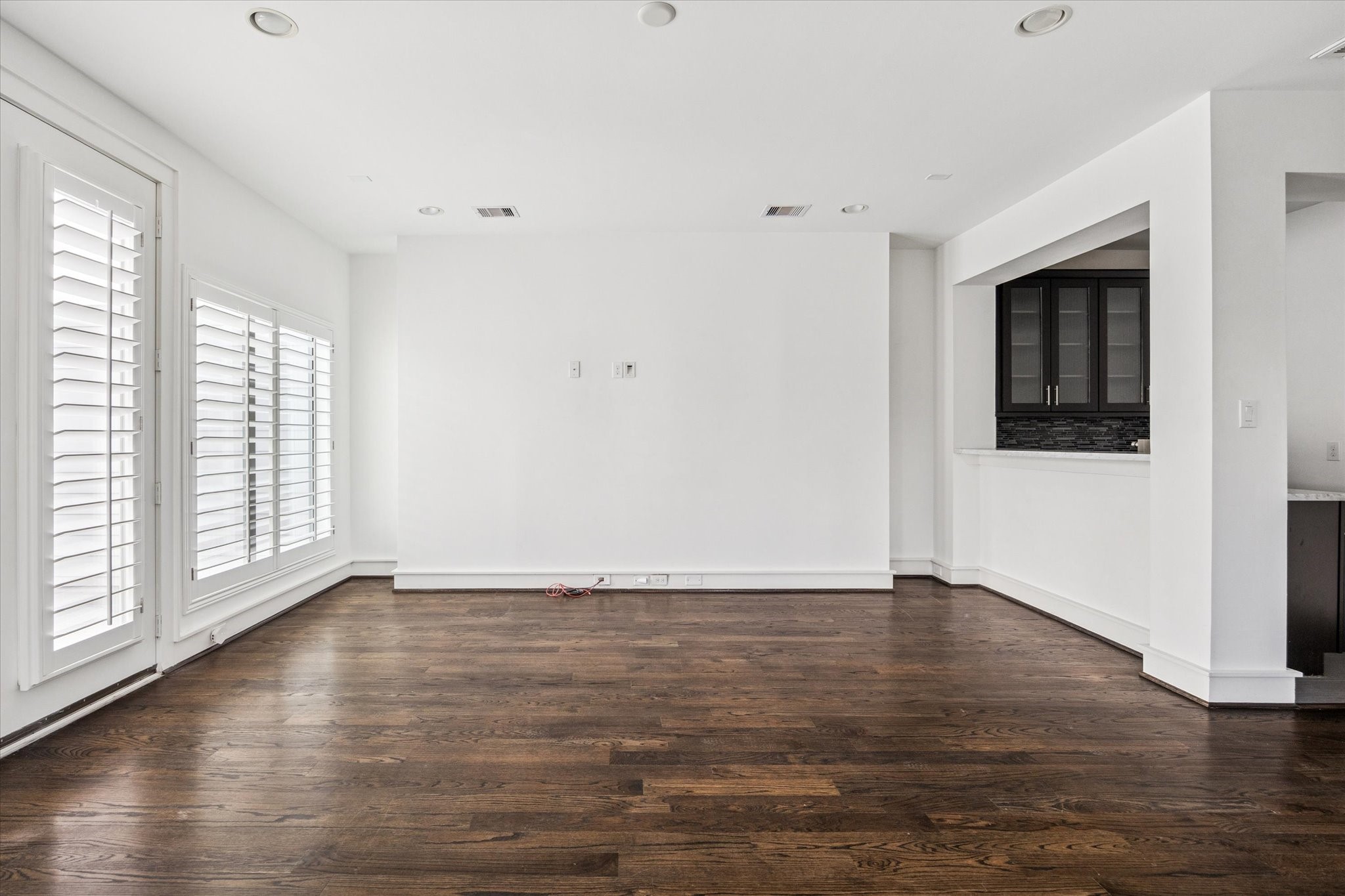 1522 Knox Street Houston, TX 77007 - Photo 26 of 43 a view of an empty room with wooden floor and a window
