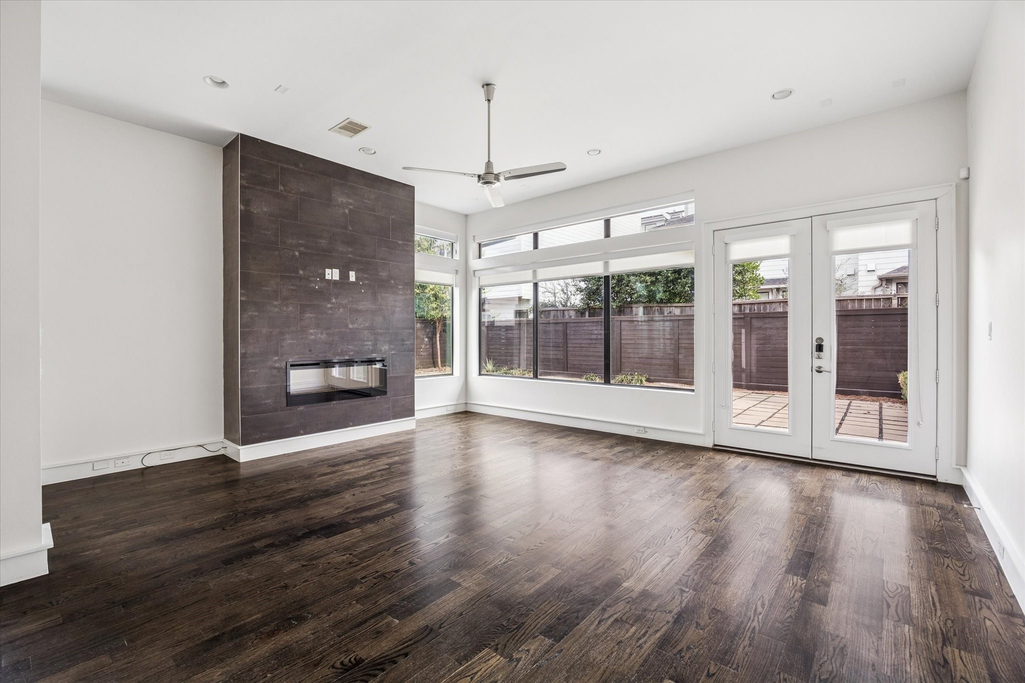1522 Knox Street Houston, TX 77007 - Photo 5 of 43 a view of a room with wooden floor a ceiling fan and windows