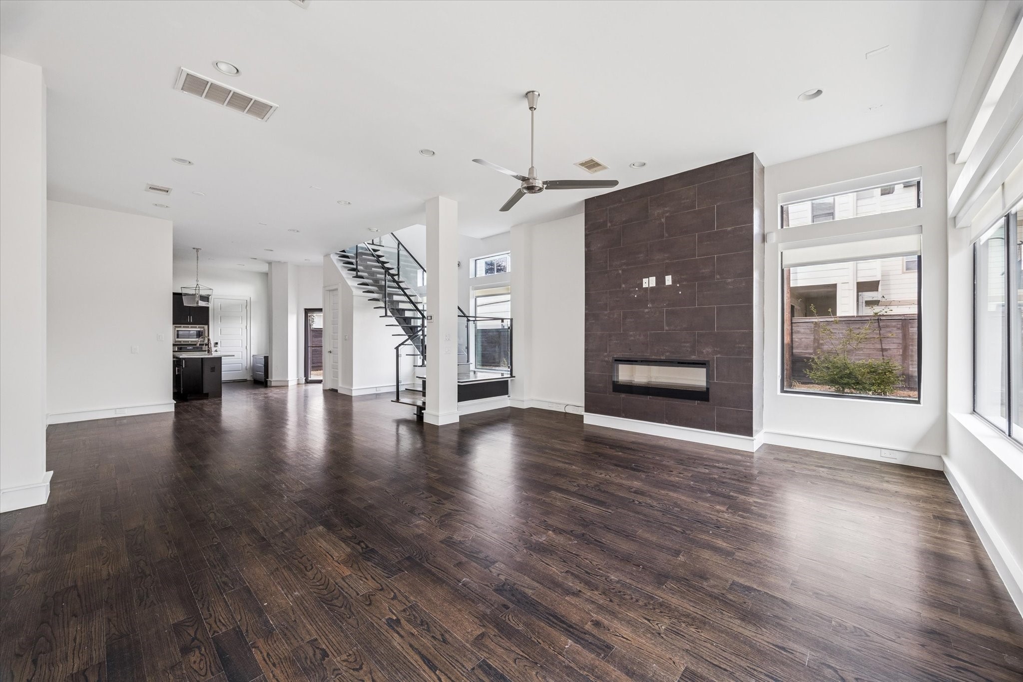 1522 Knox Street Houston, TX 77007 - Photo 6 of 43 a view of a livingroom with wooden floor a fireplace and window