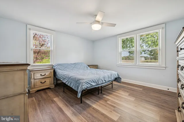 a spacious bedroom with a bed and a window