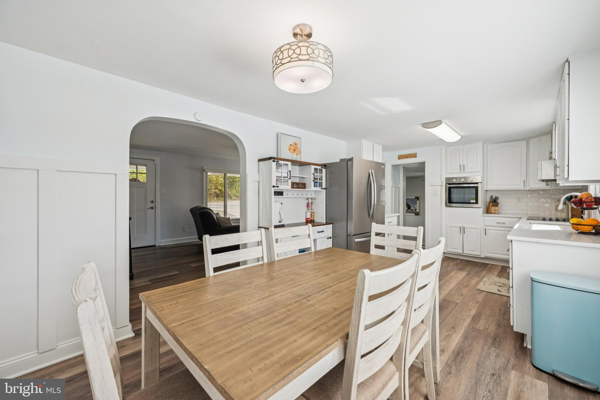 126 Repaupo Station Road Swedesboro, NJ 08085 - Photo 5 of 25 a dining room with wooden floor a chandelier a wooden table and chairs