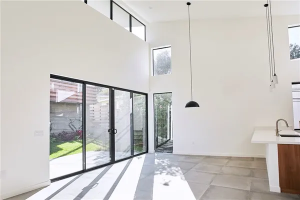 a view of a hallway with wooden floor and entryway