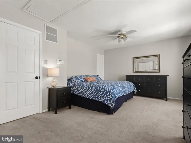 a bedroom with a bed dresser and a window