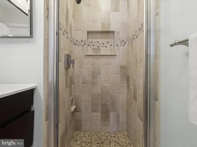 a bathroom with a shower and a sink
