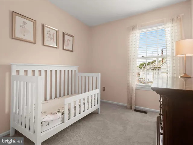 a view of a bedroom with furniture window and wooden floor