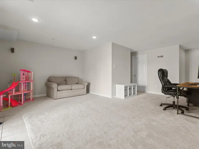 a living room with furniture and a chair