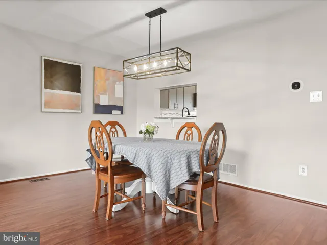a view of a dining room with furniture wooden floor and chandelier