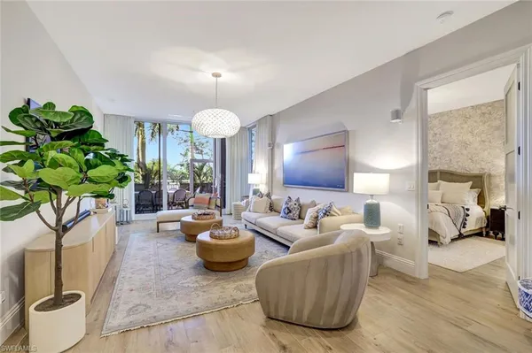 a living room with furniture and a potted plant