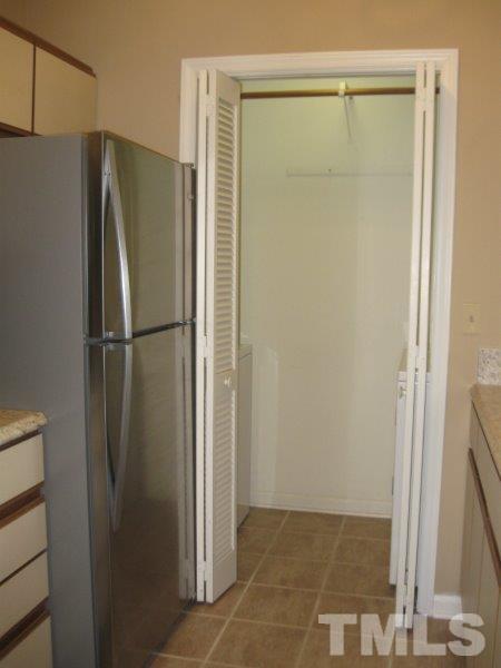 6111 Sunpointe Drive, Unit 201 Raleigh, NC 27606 - Photo 12 of 17 a view of a refrigerator in a kitchen