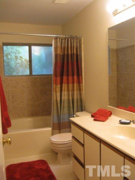 6111 Sunpointe Drive, Unit 201 Raleigh, NC 27606 - Photo 15 of 17 a bathroom with a sink toilet and shower