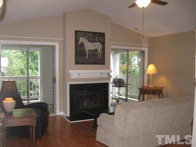 6111 Sunpointe Drive, Unit 201 Raleigh, NC 27606 - Photo 5 of 17 a living room with furniture and a fireplace