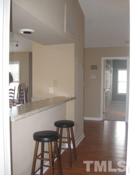 6111 Sunpointe Drive, Unit 201 Raleigh, NC 27606 - Photo 9 of 17 a kitchen with a table and chairs in it