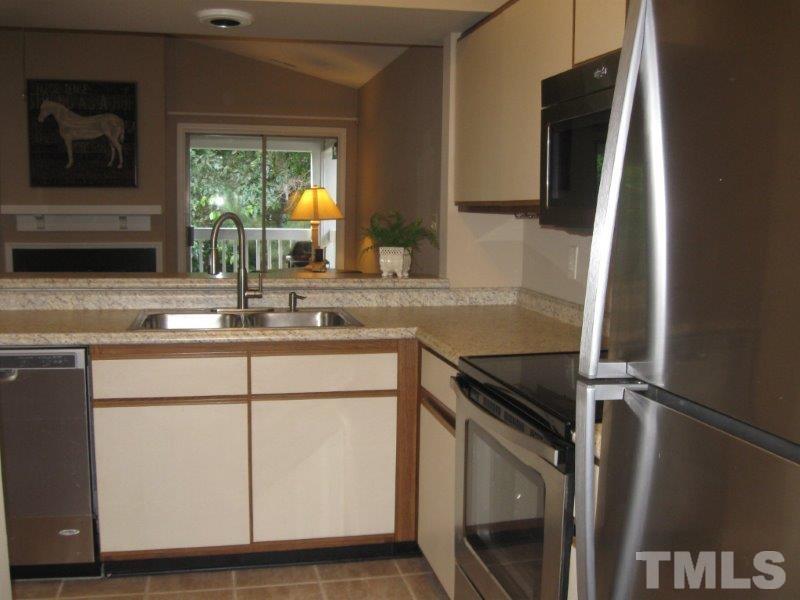 6111 Sunpointe Drive, Unit 201 Raleigh, NC 27606 - Photo 10 of 17 a kitchen with appliances a sink and a counter top space