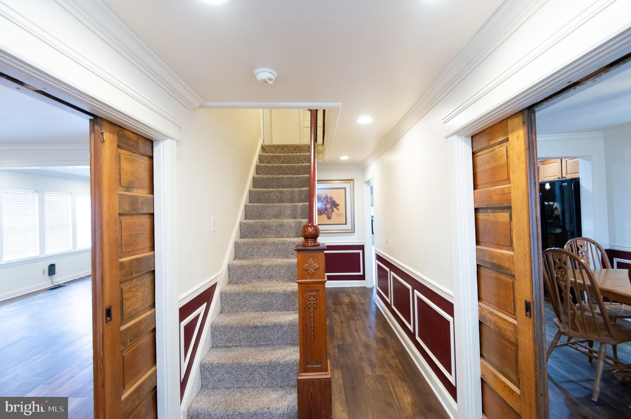 2407 Hoopers Island Road Fishing Creek, MD 21634 - Photo 26 of 69 Stair and hallway with original wood pocket doors