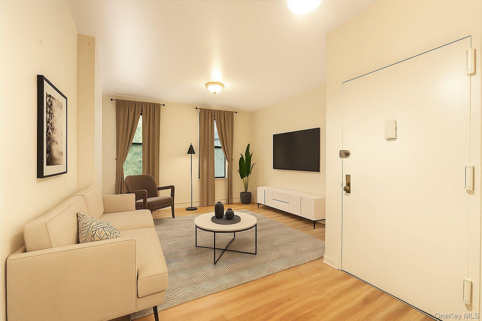 369 Marion Street, Unit 2B Brooklyn, NY 11233 - Photo 1 of 9 a living room with furniture and a flat screen tv